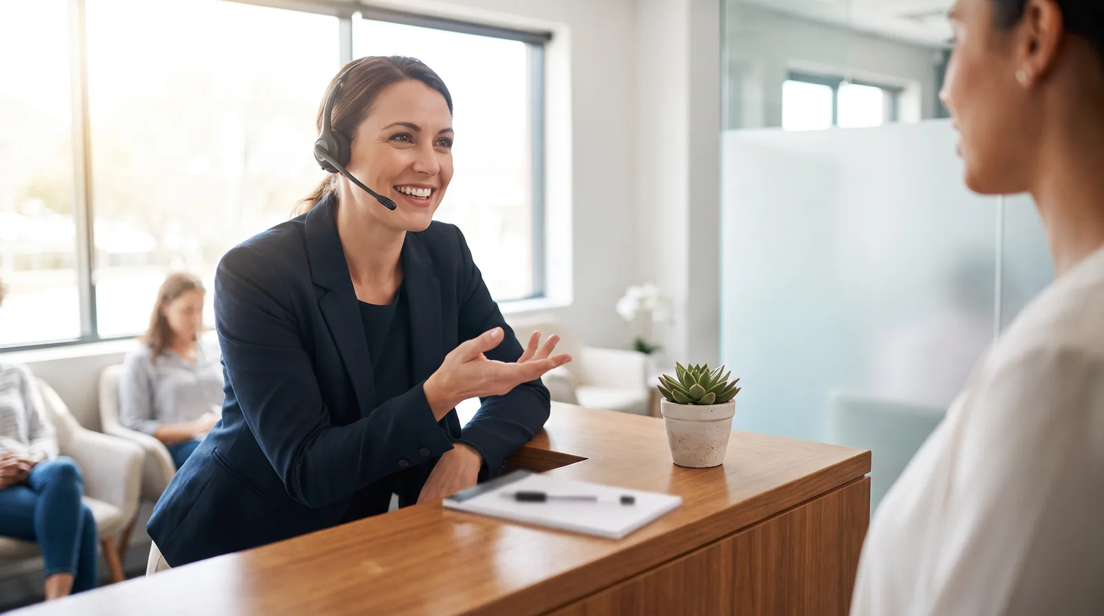 A front desk coordinator on the phone with a notepad showing a short call script: reason for call, missing teeth, timeline, financing question