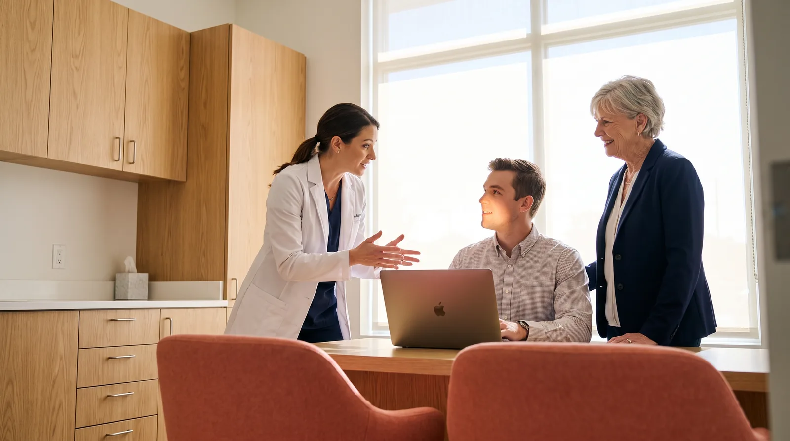 Three people in a practice office: a dentist, a young marketing coordinator at a laptop, and an office manager, faces visible, laptop angled away, bright daylight