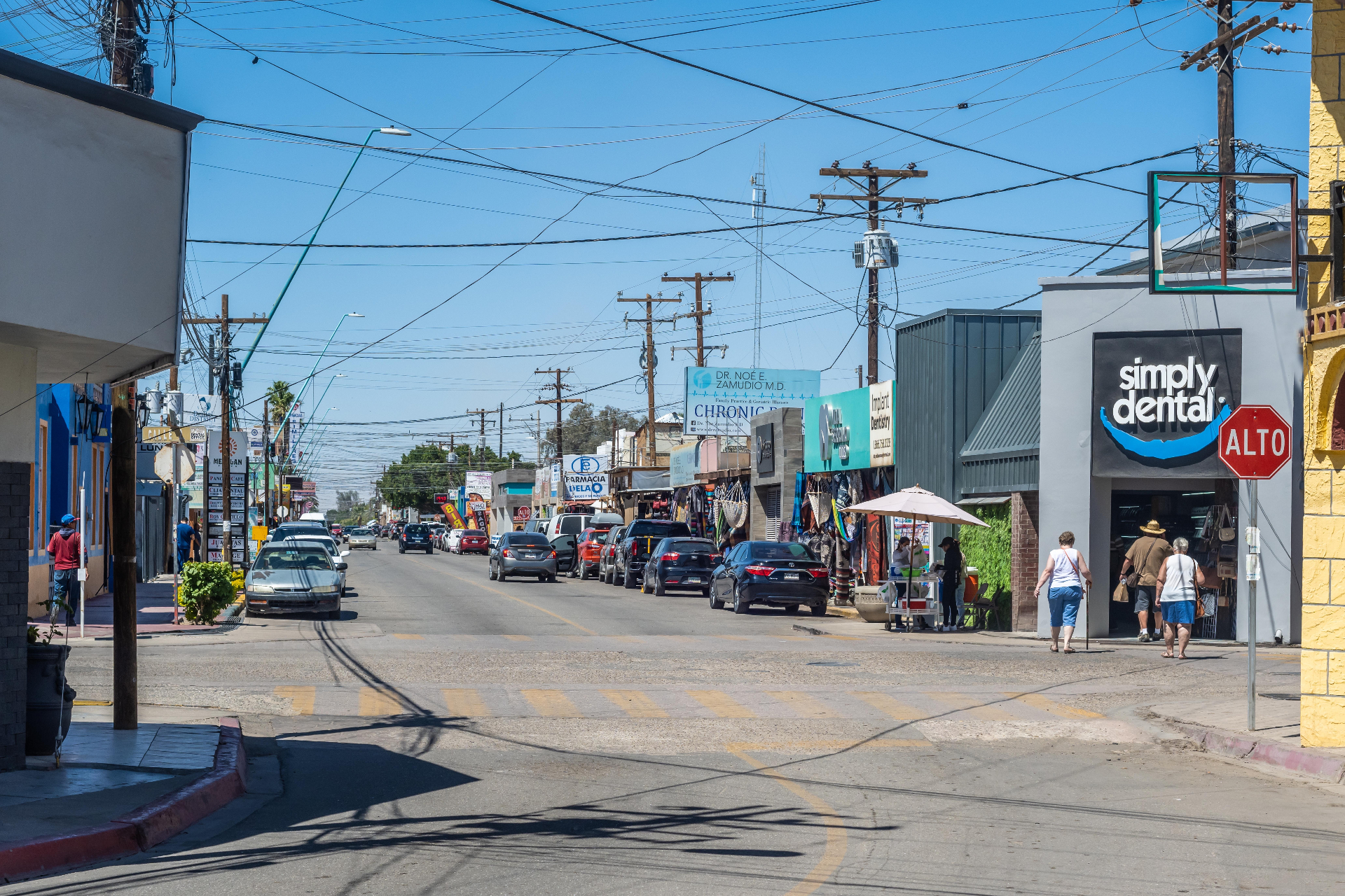 Street view of Los Algodones, Mexico (Molar City) lined with dental implant clinic signs in the busiest dental tourism town on the US-Mexico border